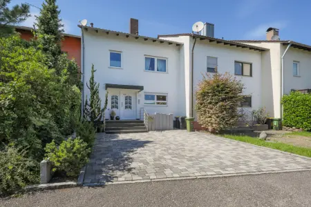 Straßenansicht der Immobilie: Familienfreundliches Reihenmittelhaus mit Einliegerbereich und Garage (Foto)