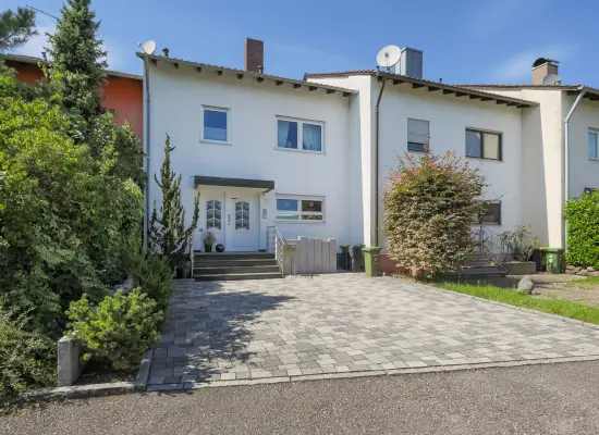Straßenansicht der Immobilie: Familienfreundliches Reihenmittelhaus mit Einliegerbereich und Garage (Foto)